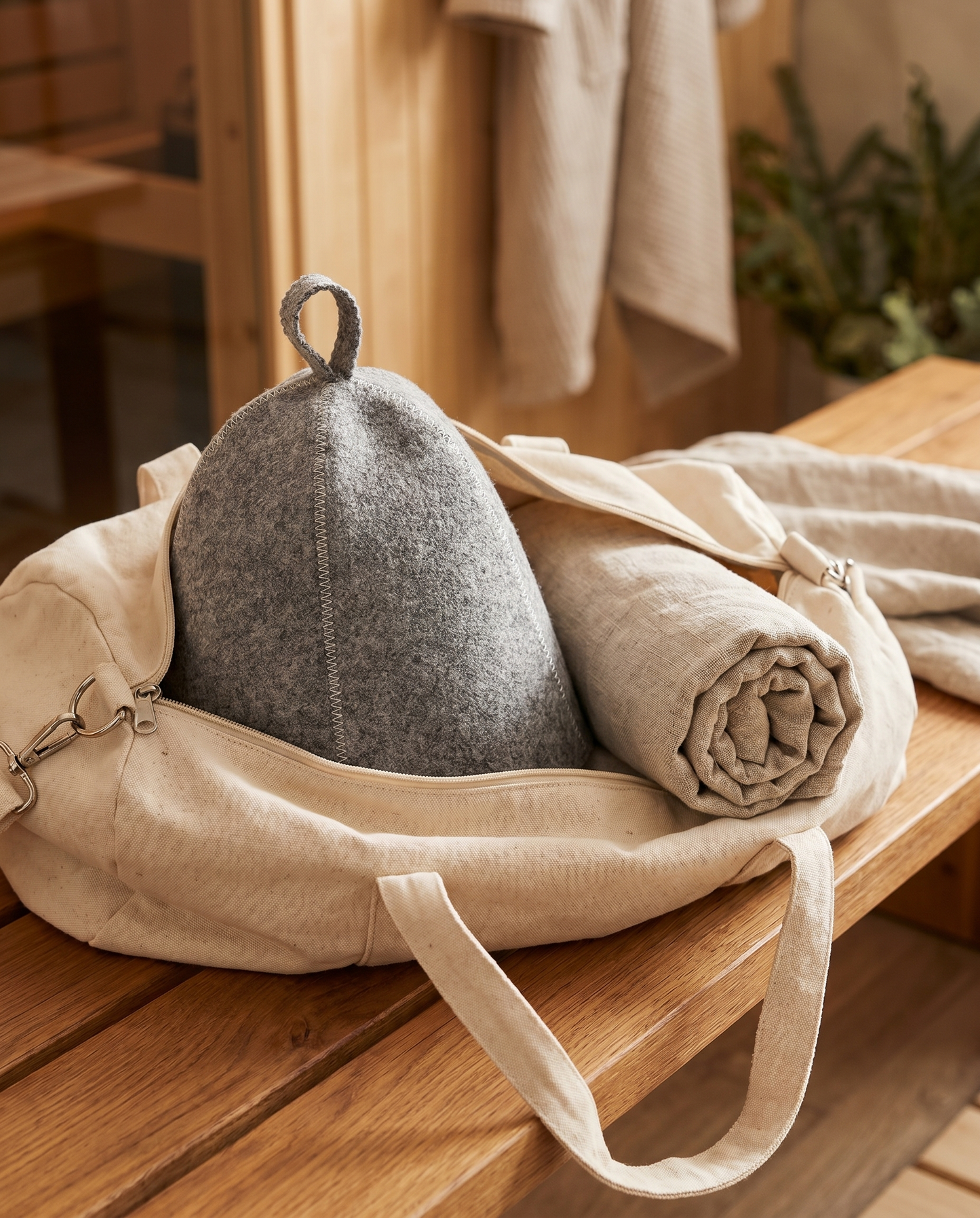 Sawna sauna hat packed in a gym bag with a rolled towel